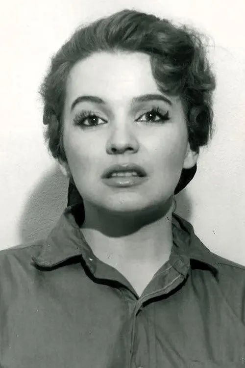 Blaze Starr interpretando a Self (footage projected over Dolores' face) (segment 