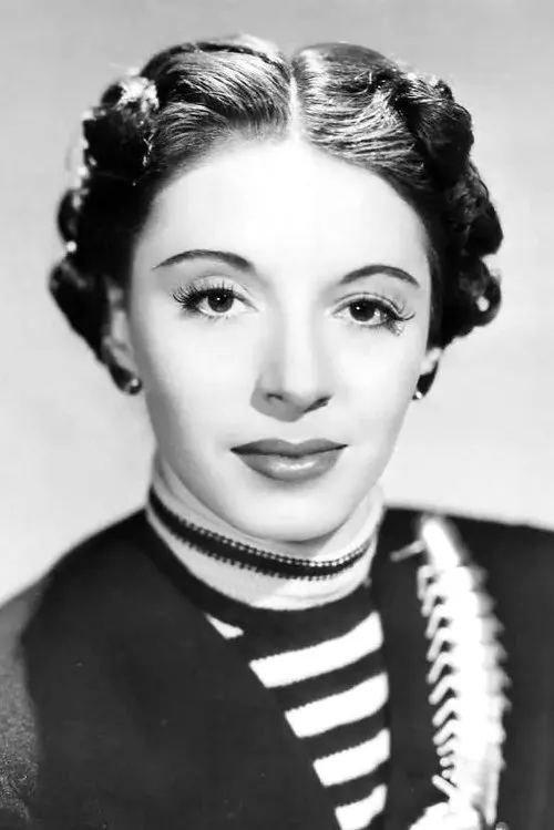 Elaine Barrie interpretando a (archive footage)