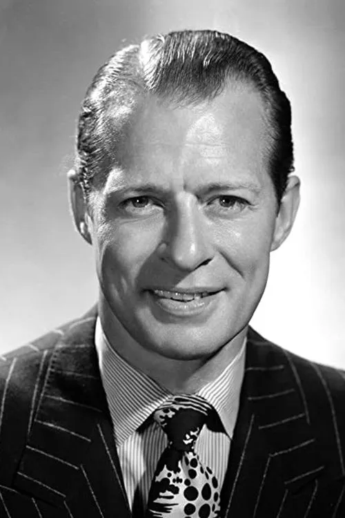 Morgan Conway interpretando a Lou Baronette