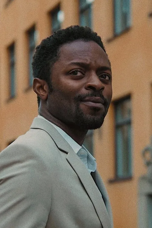 Ozzy Agu interpretando a Ebele / Adrian