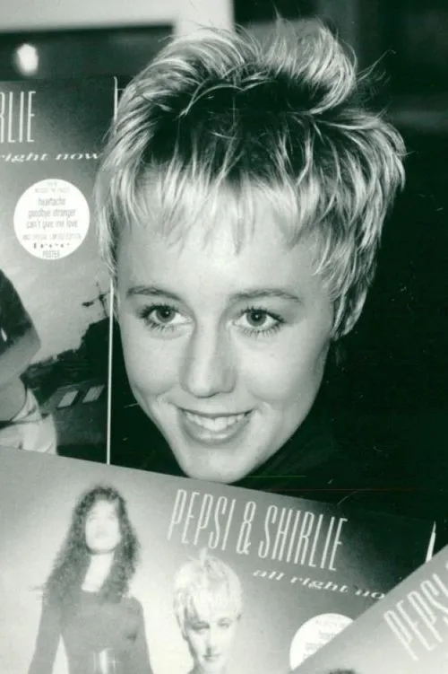 Shirlie Holliman interpretando a Self (archive footage)