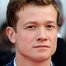 Ed Speleers como Rhys Montrose