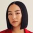 Greta Lee como Maxine
