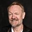 Jared Harris como Lane Pryce