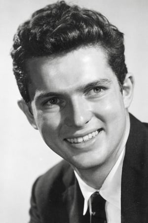 Geoffrey Horne interpretando a Ron Kesselman