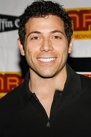 Greg Lindsay interpretando a TV Personality / Red Dog / Rex (voice)