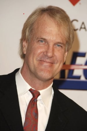 John Tesh interpretando a TV Newscaster